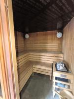 a sauna with wooden benches in a room at studio tout équipé in Jausiers