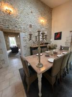 a dining room with a wooden table and chairs at Gîte Rochellier - Charente-Maritime in Cravans