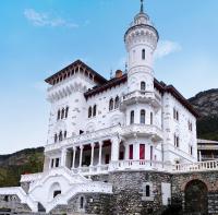 a white building with a tower on top of it at studio tout équipé in Jausiers