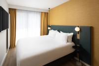 a bedroom with a large white bed and a window at Residence Inn by Marriott Paris Didot Montparnasse in Paris