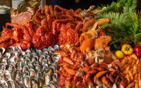 a display of different types of seafood on a table at Eastin Grand Hotel Sathorn in Bangkok
