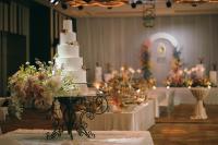 a white wedding cake sitting on a table in a room at Eastin Grand Hotel Sathorn in Bangkok