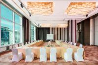 a large conference room with a long table and white chairs at Eastin Grand Hotel Sathorn in Bangkok