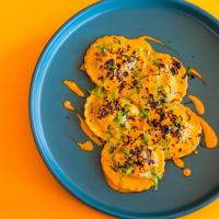 a blue plate with food on a orange background at Eastin Grand Hotel Sathorn in Bangkok