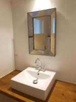 a bathroom with a white sink and a mirror at Pyrénées Passions - Gîtes de Charmes &amp; Caractère in Estadens