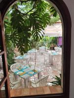 Una ventana arqueada con mesas y sillas en un jardín. en Hostal Mi Campaña, en Denia