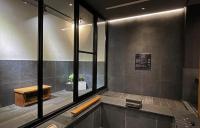 a bathroom with a bath tub with a window at Onsen Papawaqa in Tai&#39;an