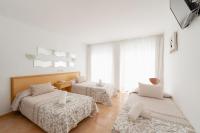 A bed or beds in a room at Hotel Santa Faz