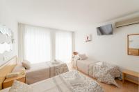 A bed or beds in a room at Hotel Santa Faz