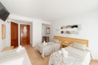 A bed or beds in a room at Hotel Santa Faz