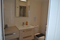 a bathroom with a sink and a toilet and a mirror at Hotel Ty Gwenn La Baule in La Baule