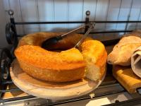 two loaves of bread on a plate with a spoon in it at Hotel Ty Gwenn La Baule in La Baule