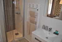 a bathroom with a shower and a sink and a mirror at Hotel Ty Gwenn La Baule in La Baule