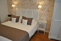 a bedroom with a bed with two pillows on it at Hotel Ty Gwenn La Baule in La Baule