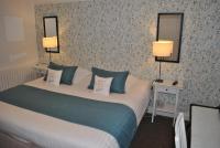 a hotel room with a bed with two lamps on it at Hotel Ty Gwenn La Baule in La Baule