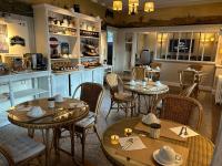 a restaurant with tables and chairs in a room at Hotel Ty Gwenn La Baule in La Baule