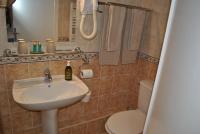 a bathroom with a sink and a toilet at Hotel Ty Gwenn La Baule in La Baule