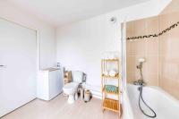 a bathroom with a toilet and a bath tub at Duplex cosy - Proche Aéroport Paris CDG in Montfermeil