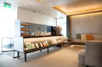 a living room with a couch and a table with books at Dandy Hotel-Daan Park Branch in Taipei