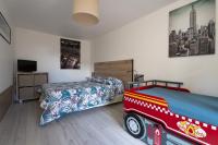 a bedroom with two beds and a fire truck bed at Gite du Moulin in Saint-Laurent-dʼAndenay