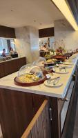 a buffet line with plates of food in a restaurant at Apec-Mandala - Condotel - Ocean view-ADP TOUR in Ấp Thiẹn Ái
