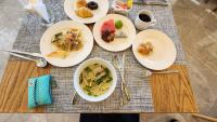 a table with plates of food on a table at Apec-Mandala - Condotel - Ocean view-ADP TOUR in Ấp Thiẹn Ái