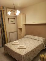 a bedroom with a bed with two towels on it at Hotel Henry in Venice