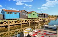 a group of houses on a dock with boats in the water at 4 Bedroom Cozy Home In Royan in Royan