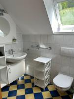 a white bathroom with a sink and a toilet at Haus-Eckberg 101 in Gamlitz