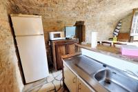 a kitchen with a white refrigerator and a sink at Maison d&#39;une chambre avec jardin clos a Tour de Faure in Tour-de-Faure