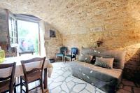 a living room with a couch and a table at Maison d&#39;une chambre avec jardin clos a Tour de Faure in Tour-de-Faure