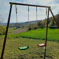 two swings with a field in the background at Apartman Potocki in Krapina