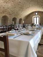 a long white table with wine glasses and napkins at Masseria Fanizzi in Conversano