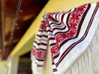 a red and white towel hanging on a wall at Casa Otilia in Chişcău