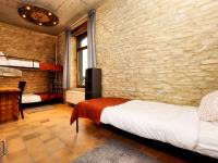 a bedroom with two beds and a brick wall at Fancy Holiday Home in Sainte C cile with Pool House Indoor Pool in Sainte-Cécile