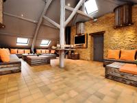a large room with couches and a tv in a building at Fancy Holiday Home in Sainte C cile with Pool House Indoor Pool in Sainte-Cécile