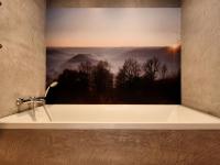 a bath tub with a picture of a mountain view at Fancy Holiday Home in Sainte C cile with Pool House Indoor Pool in Sainte-Cécile