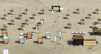 an overhead view of a beach with chairs and umbrellas at Appartement moderne CASABAY BEACH Sidi Rahal in Sidi Rahal