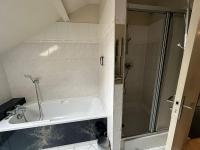 a bathroom with a shower and a white bath tub at Comme à Garros - 218 in Mont-Saint-Aignan