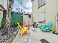 a group of colorful chairs sitting next to a building at Logement 4 personnes avec terrasse privative ! in Meaux