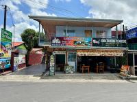 una tienda al lado de una calle con un edificio en Cabinas Las Palmas del Sol, en Fortuna