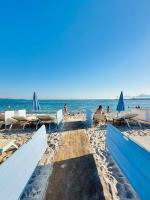 a beach with chairs and people sitting on the sand at Cannes NG - Appartement à 10 mn du Palais des Festivals in Cannes