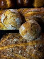 a pile of loaves of bread on a table at La Ferme du Bien-etre in Saint-Julien-Chapteuil