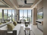 a living room with a white couch and some windows at Amari Phuket in Patong Beach