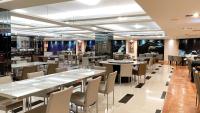 a dining room with tables and chairs in a restaurant at Delton Hotel in Kaohsiung