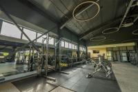 a gym with several treadmills and machines in it at ARCA Resort 