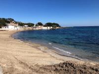 a beach with the ocean and houses in the background at Chez Skadi amazing sea view in Roquebrune-sur-Argens