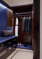a dressing room with blue walls and a closet at The Peninsula Chicago in Chicago