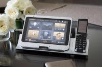 a tablet and a cell phone on a table with flowers at The Peninsula Chicago in Chicago