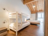 two bunk beds in a room with wooden floors at Emma Top 3 XL in Dienten am Hochkönig
